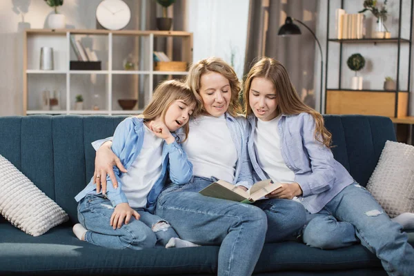 Loving Mother Two Little Kids Reading Book Together Hugging Sitting — Stok fotoğraf