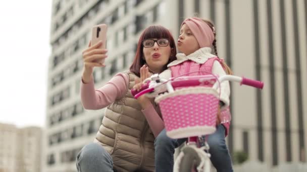 Привлекательная Счастливая Молодая Мама Учит Свою Милую Дочь Кататься Велосипеде — стоковое видео