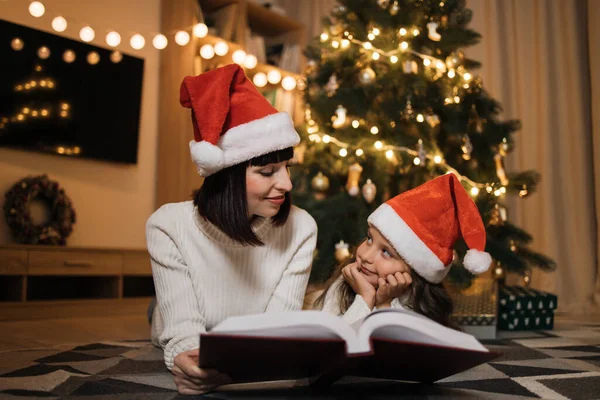 Pretty Young Mother Santa Hat Reading Magical Fairy Tale Book — Stock Photo, Image