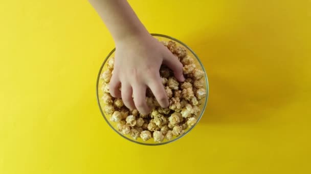 Family Hands Grab Popcorn Glass Bowl Sweet Popcorn Yellow Background — Stock Video