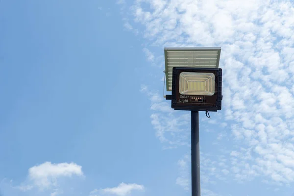 Close up street or garden lamp post with solar cell panel energy (against blue sky background)renewable energy concept.