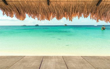 Gaussian Blur image hut on the sand beach to see the blue aqua seascape represent minimal summer vacation time slow and easily relaxation seaside in a happy holiday.