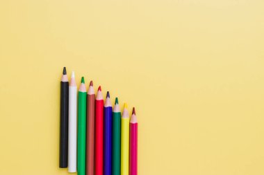 Background from color pencils on yellow paper. Color pencil with copy space isolated on yellow background. Abstract, creative and education concept.
