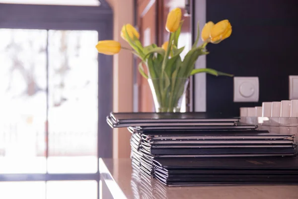 Stack of menus lying on table at a coffee shop on a winter day