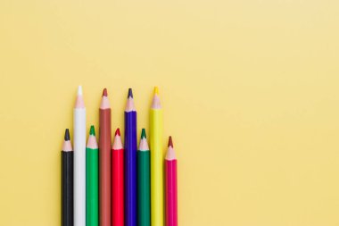 Background from color pencils on yellow paper. Color pencil with copy space isolated on yellow background. Abstract, creative and education concept.