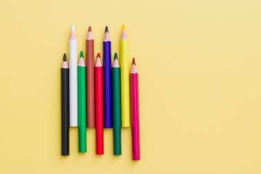 Background from color pencils on yellow paper. Color pencil with copy space isolated on yellow background. Abstract, creative and education concept.