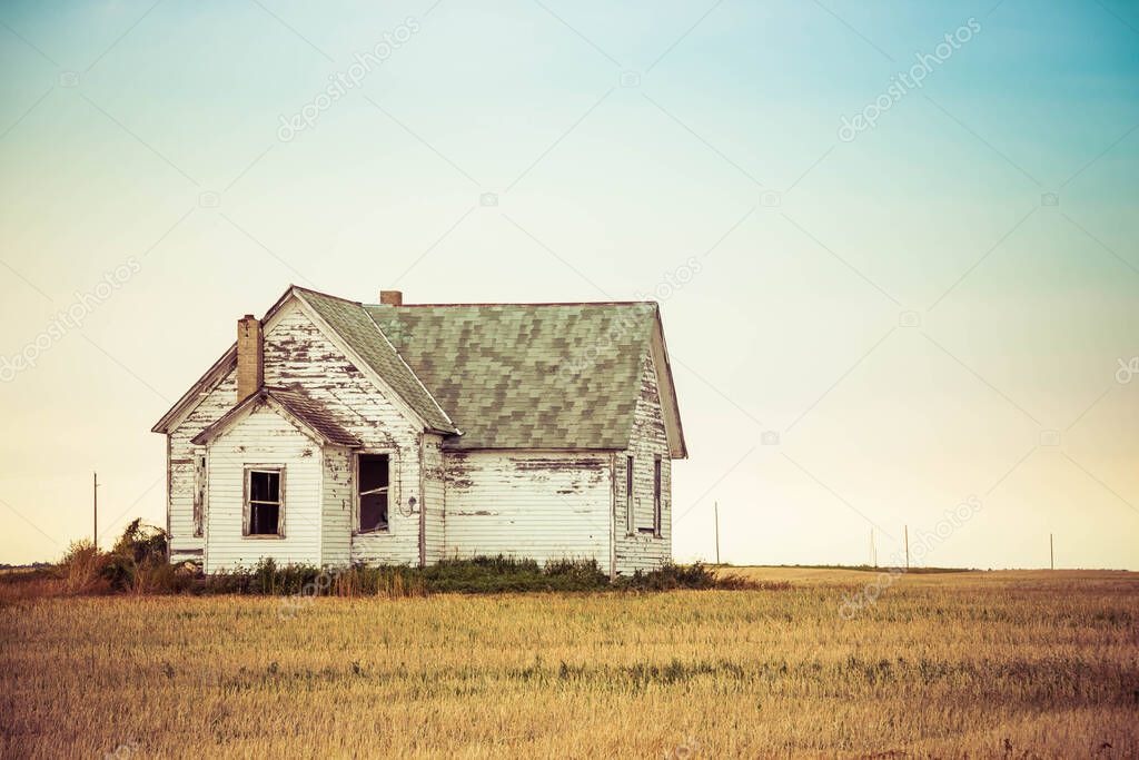 A little house on the prairie of North Dakota in the evening.