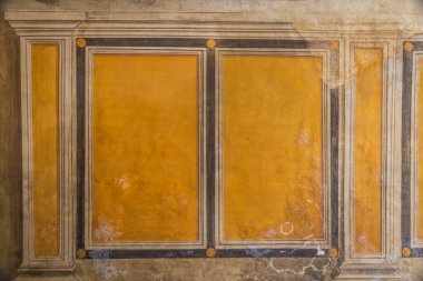A detail of a medieval fresco painted on the wall of a building in the Italian village of San Gimignano in Tuscany, Italy, Europe.
