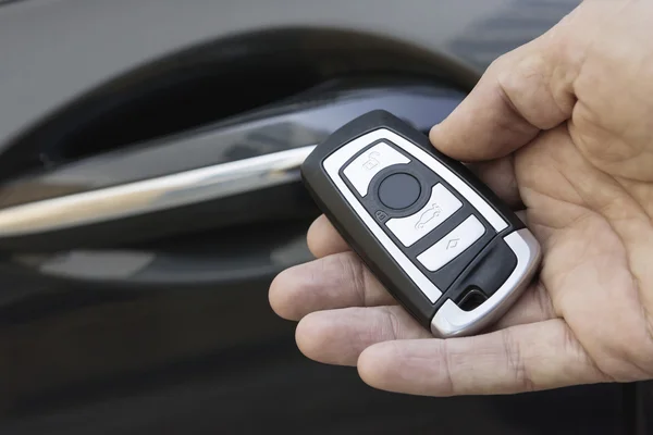 Closeup of male hand holding remote control car key