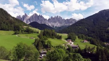 Relaxing drone view of St Maddalena in green Vall de Funes, Dolomites (Italy)