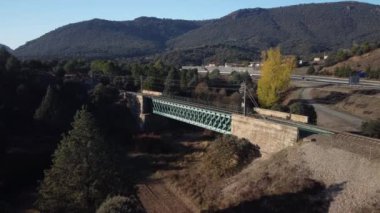 Aerial footage of an iron railroad bridge located in the Depeaperros line from Seville to Alcazar de San Juan in Spain. A perfect example of ancient railroad structure that nowadays is still in use