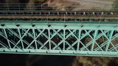 Aerial footage of an iron railroad bridge located in the Depeaperros line from Seville to Alcazar de San Juan in Spain. A perfect example of ancient railroad structure that nowadays is still in use