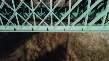 Aerial footage of an iron railroad bridge located in the Depeaperros line from Seville to Alcazar de San Juan in Spain. A perfect example of ancient railroad structure that nowadays is still in use
