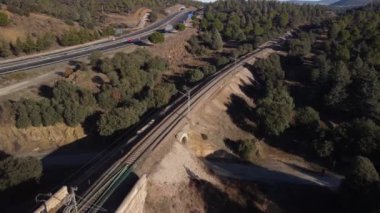 Aerial footage of an iron railroad bridge located in the Depeaperros line from Seville to Alcazar de San Juan in Spain. A perfect example of ancient railroad structure that nowadays is still in use