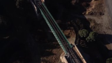 Aerial footage of an iron railroad bridge located in the Depeaperros line from Seville to Alcazar de San Juan in Spain. A perfect example of ancient railroad structure that nowadays is still in use