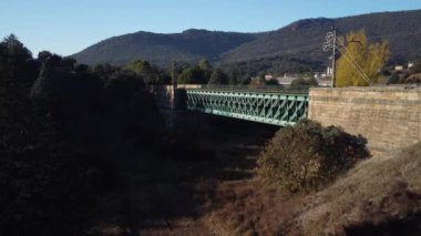 Aerial footage of an iron railroad bridge located in the Depeaperros line from Seville to Alcazar de San Juan in Spain. A perfect example of ancient railroad structure that nowadays is still in use