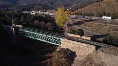 Aerial footage of an iron railroad bridge located in the Depeaperros line from Seville to Alcazar de San Juan in Spain. A perfect example of ancient railroad structure that nowadays is still in use