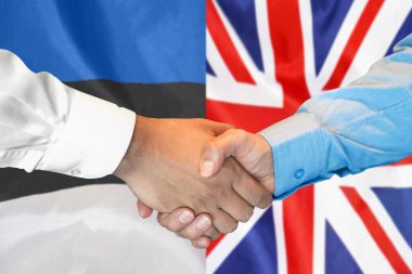 Business handshake on background of two flags. Men handshake on background of Estonia and UK flag. Support concept