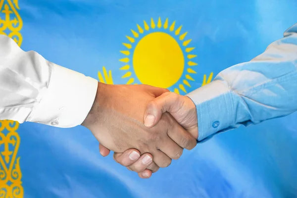 Business handshake on Kazakhstan flag background. Men shaking hands on Luxembourg flag background. Support concept in Kazakhstan