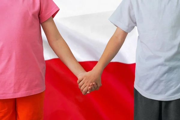 Two children joined hands on flag Poland background. Boy and girl joined hands on background flag of Poland. Concept of family and parenting in Poland