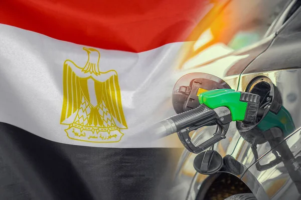 Car with a fuel injector on Egypt flag background. Record prices fuel for population. Gasoline price increase during energy and fuel world crisis in Egypt