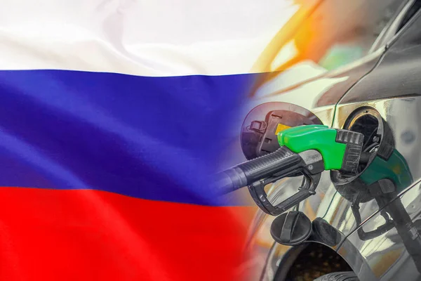 Car with a fuel injector on Russia flag background. Record prices fuel for population. Gasoline price increase during energy and fuel world crisis in Russia