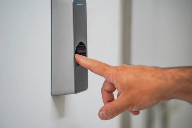 Opening door with fingerprint. Fingerprint used as an identification method on a door lock. Fingerprint identification people on door lock