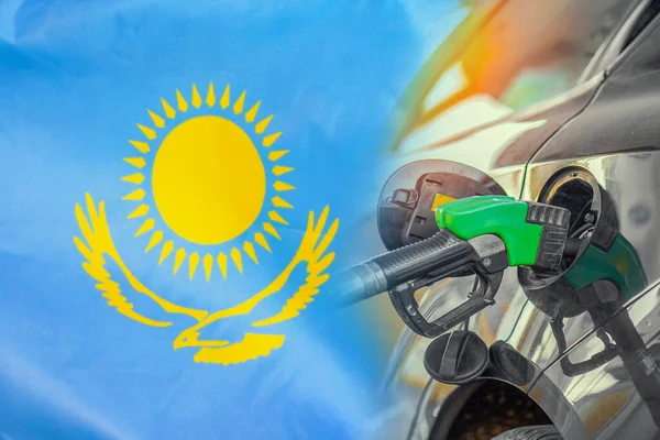 Car with a fuel injector on Kazakhstan flag background. Record prices fuel for population. Gasoline price increase during energy and fuel world crisis in Kazakhstan