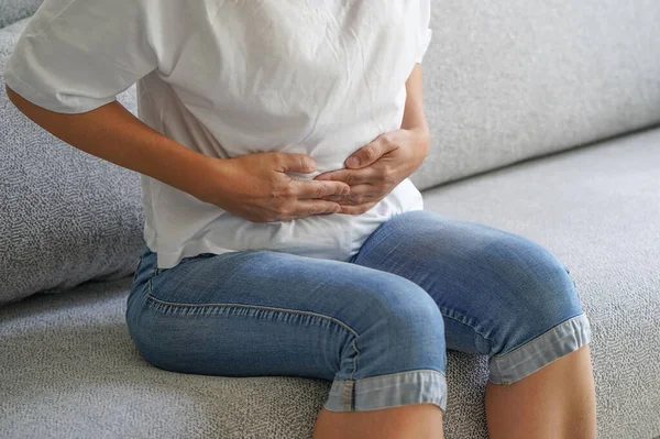 Woman Siting Sofa Holding Her Hands Her Stomach Woman Having — стоковое фото