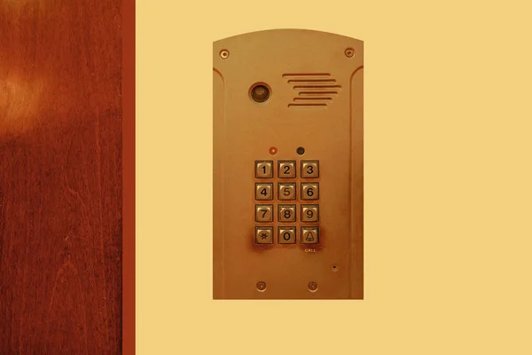 Close-up push-button lock of entrance doors. Video intercom system on wall to enter office. Intercum with a camera in office. New video intercom. Video intercom display on wall near the entrance door