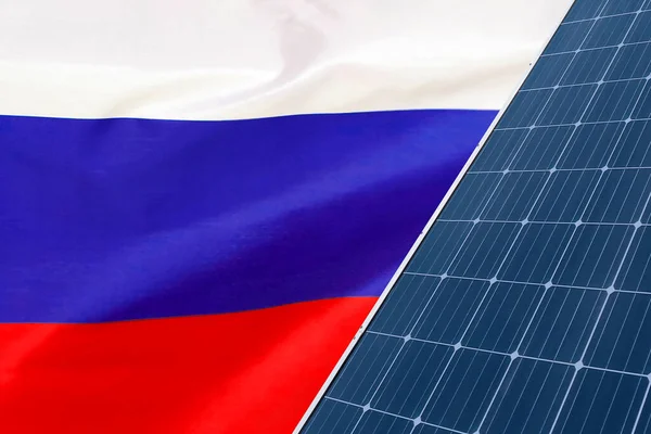 Solar panels against flag Russia background. Solar battery generates a pure electricity. Concept of sustainable resources and renewable energy in Russia