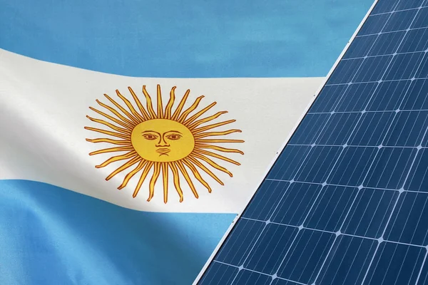 Solar panels against flag Argentina background. Solar battery generates a pure electricity. Concept of sustainable resources and renewable energy in Argentina