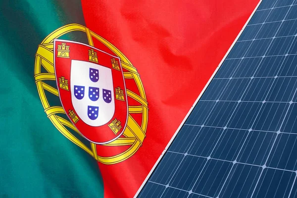 Solar panels against flag Portugal background. Solar battery generates a pure electricity. Concept of sustainable resources and renewable energy in Portugal