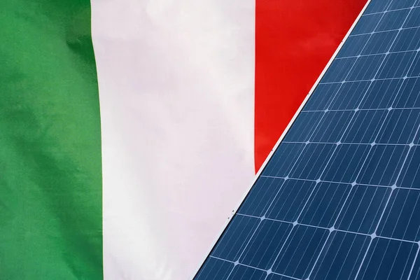 Solar panels against flag Italy background. Solar battery generates a pure electricity. Concept of sustainable resources and renewable energy in Italy