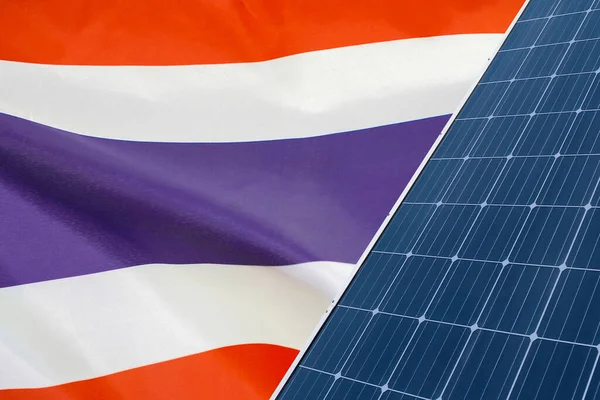 Solar panels against flag Thailand background. Solar battery generates a pure electricity. Concept of sustainable resources and renewable energy in Thailand