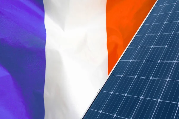 Solar panels against flag France background. Solar battery generates a pure electricity. Concept of sustainable resources and renewable energy in France