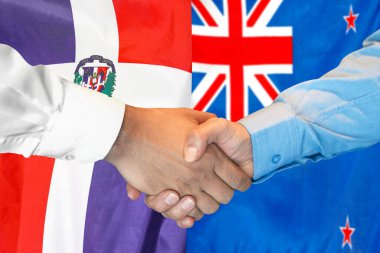 Business handshake on background of two flags. Men handshake on background of Dominican Republic and New Zealand flag. Support concept