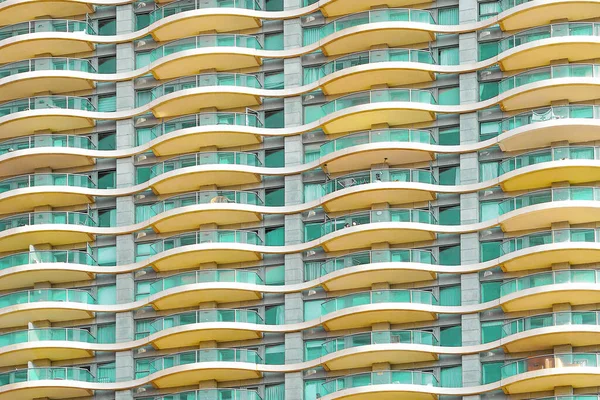 Glass green balconies windows of facade modern city building. Facade of building texture closeup