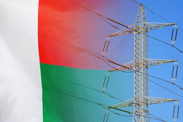 Madagascar flag on electric pole background. Power shortage and increased energy consumption in Madagascar. Energy development and energy crisis in Madagascar