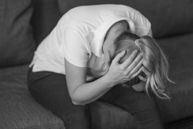 Stresli bir kadının el ele tutuşmasının siyah ve beyaz görüntüsü. Malulen depresyonda olan mutsuz bir kadın. Cinsel istismar
