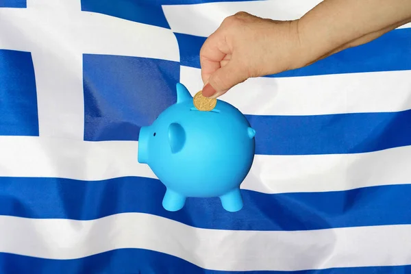 Hand Elderly Woman Putting Coin Piggy Bank Greece Flag Background — Stock Photo, Image