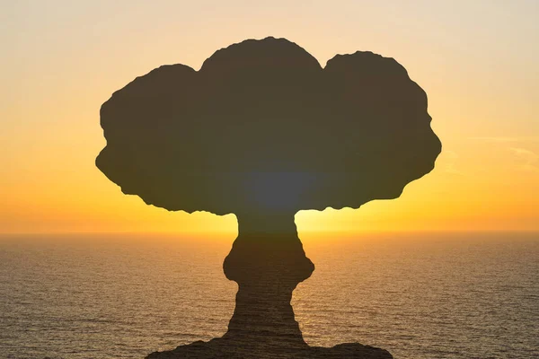 Atomic bomb explosion mushroom on sunset over sea or calm ocean. Nuclear explosion. Danger of nuclear war illustration in sea or ocean
