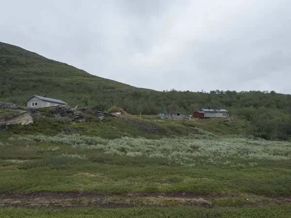 位于Virihaure湖的Sami村Staloluokta，有房屋、农舍、山区和桦树。在Padjelantaleden徒步旅行的路上，夏日闷闷不乐，多雾。瑞典拉普兰景观 — 图库照片
