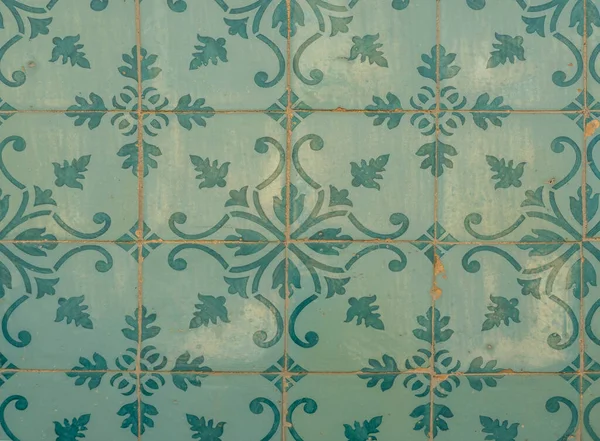 Green ceramic tiles from facade of old houses in Lisbon Portugal. Portuguese traditional Azulejos decorative artistic design background, creative texture surface.