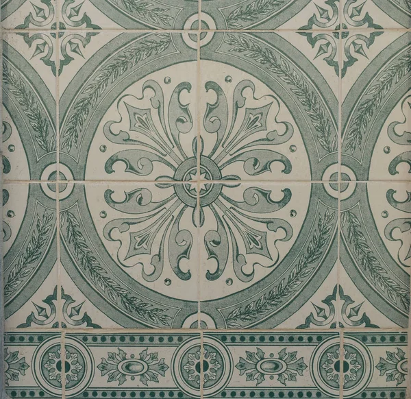 Green ceramic tiles from facade of old houses in Lisbon Portugal. Portuguese traditional Azulejos decorative artistic design background, creative texture surface.