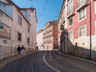 Lisbon, Portugal, October 24, 2021: View of steep narrow Lisbon streets at medieval quarter Alfama at Santa Maria Maior district