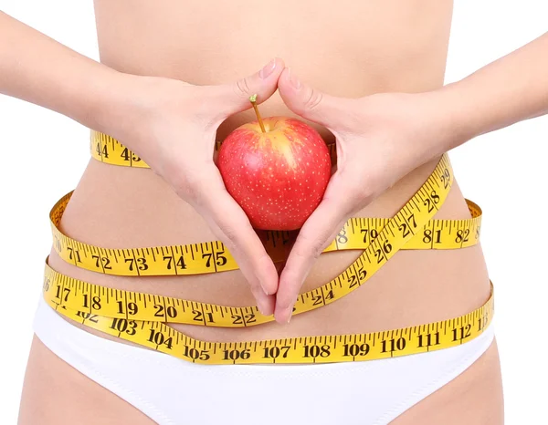 Woman's waist with measuring tape holding red apple — Stock Photo, Image
