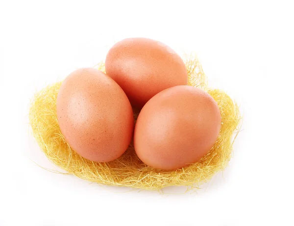 Three egg in grassy nest isolated on white background — Stock Photo, Image