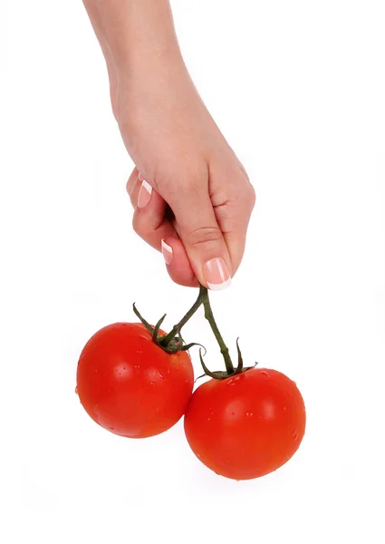 Pomodori maturi in mano femminile isolati su bianco — Foto Stock