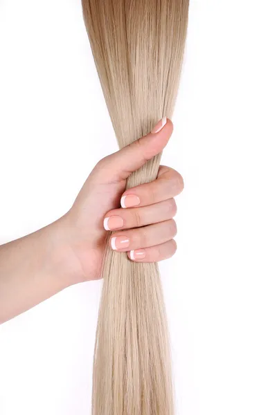 Cabelo loiro na mão feminina isolado em branco — Fotografia de Stock